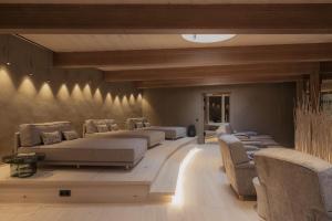 a bedroom with three beds and a couch at Berghotel Schlossanger Alp in Pfronten