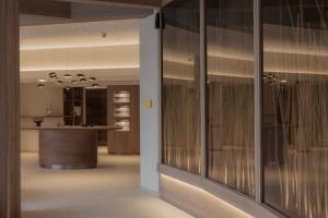 a room with glass doors and a kitchen with a counter at Berghotel Schlossanger Alp in Pfronten +129 photos