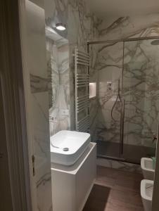 a white bathroom with a sink and a shower at Classico in Sanremo +13 photos