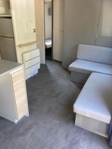 a room with two beds and a dresser in it at Bonne Anse plage 411 mobile home 3 chambres in Les Mathes