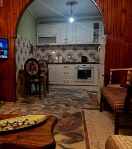 a kitchen with an archway and a table in a room at Apartman 23 in Kraljevo +13 photos