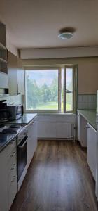 an empty kitchen with a large window in a kitchen at Pankkikallio 7 in Sorsakoski