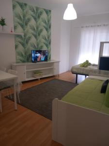 a living room with a tv and a couch at Lila's House in Peniche