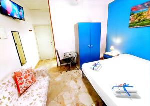 a bedroom with a bed and a couch and a tv at B&B D'Amico87 in Bagheria