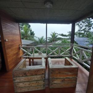 a balcony with wooden crates and a table and a view at Mionga in Santa Cruz +20 photos