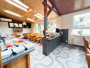 a kitchen and dining room with tables and chairs at VILLA SUNNY ROSE Bed & Breakfast in Świnoujście