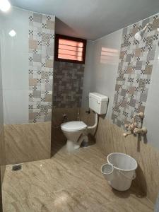 a bathroom with a toilet and a shower and a sink at Entire 2BHK and a garden parking in Tiruvannāmalai