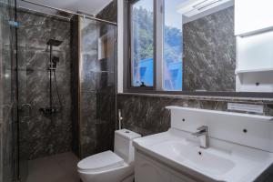 a bathroom with a toilet and a sink and a shower at The July - Coliving by Kegotel in Vung Tau +20 photos
