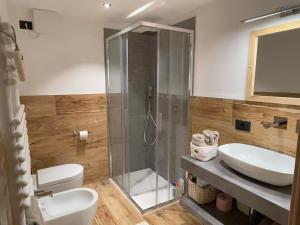 a bathroom with a shower and a toilet and a sink at Il Sole delle Dolomiti in Campestrin +25 photos