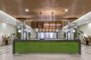 a lobby with a green counter in a building at Condo Unit at La Verti Residences in Manila