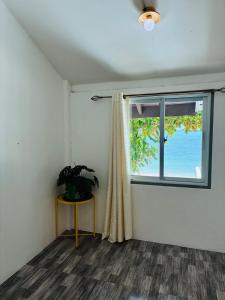 a room with a window and a plant on a table at Oceanfront Villa at Bang po Beach-Koh Rooms in Ban Bang Po +39 photos