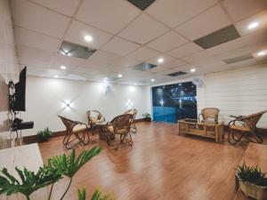 a room with chairs and a table and a stage at Insara Cottage in Shillong