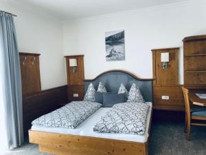 a bedroom with a large bed with a wooden frame at Das Unterwimm in Wagrain