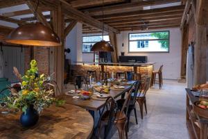 a dining room with wooden tables and chairs at Landurlaub mit neugierigen Blicken in den Pferdestall, eingezäuntem Garten, Kamin und Sauna in Rot am See