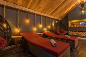 a room with couches and chairs and a fireplace at Boutique Hotel beim Lipp - Restaurant & Spa in Roßhaupten