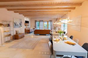 a dining room and living room with a table and chairs at Landvilla Diebach in Diebach