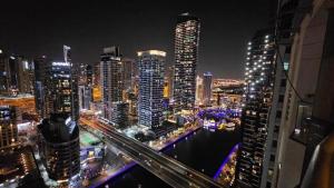 a view of a city at night with buildings at Superb Family Friendly Beach-Front Whole Flat, Great Views in Dubai
