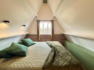 a bed in a room with a window at Bosgeluk Durbuy in Durbuy +70 photos