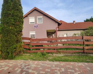 a house with a fence in front of it at Bella Vendégház in Székesfehérvár