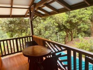 a balcony with a table and chairs and a pool at Vida Buena in Drake