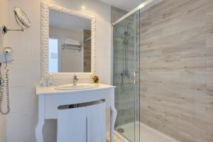 a bathroom with a sink and a glass shower at Cala Millor Garden Hotel - Adults Only in Cala Millor
