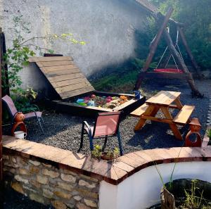 a miniature garden with a picnic table and a table and chairs at Main Road Seven Vendégház in Füzérradvány