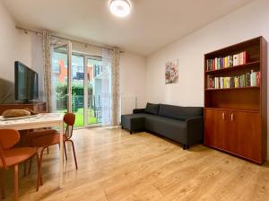 a living room with a couch and a table at Cozy Stay Apartment Szaserów in Warsaw