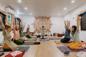 a group of people sitting on the floor in a yoga class at Niru Yoga Homestay sound healing & hiking retreat in Bhaktapur