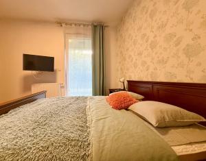a bedroom with a bed with a television on the wall at Cozy Stay Apartment Szaserów in Warsaw