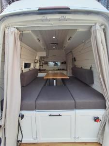 a table in the back of a camper van with a table in it at Cozy Campervan Albania in Tirana