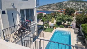 a bike on a balcony next to a swimming pool at Vila Hrvatska in Ražanj +25 photos