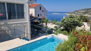 a villa with a swimming pool and a view of the ocean at Vila Hrvatska in Ražanj