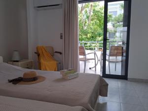 a bedroom with a bed with a hat on it at Portobelis Apartments in Sitia