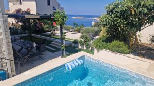 a swimming pool with a view of the ocean at Vila Hrvatska in Ražanj
