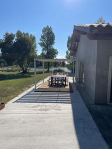 a picnic shelter with picnic tables in a park at l'Héberge du Lac d'Isachris (Médoc) in Queyrac +6 photos