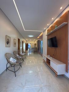 a hospital hallway with chairs and a tv on a wall at Casa da Ladeira in Barreirinhas +14 photos