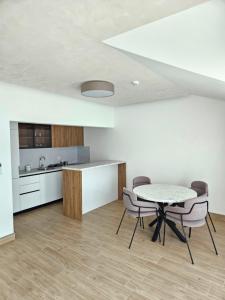 a kitchen and dining room with a table and chairs at Vile MonteMar in Herceg-Novi