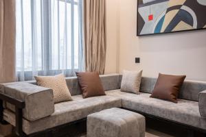 a couch in a living room with a large window at الرابية - شقق فارهة - دخـول ذكي in Abha