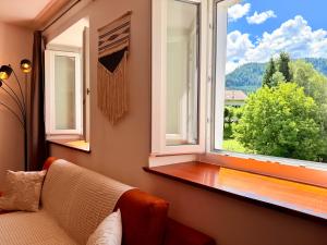 a living room with a couch and a window at Castellino di Castello di fiemme in Castello di Fiemme +11 photos