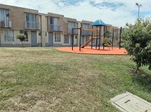 a playground with a slide in front of a building at Beautiful Cozy House - Hermosa Casa Acogedora in Ibagué