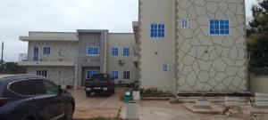 a car parked in a parking lot in front of a building at Dankay City Lodge in Abesem