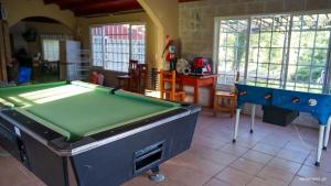 a room with two pool tables in a room at Complejo Lago Chico in Tanti