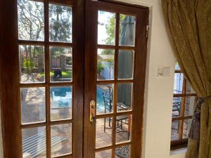 an open door with a view of a pool at Mi casa guesthouse in Gaborone