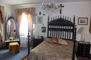 a bedroom with a large bed and a chandelier at Vila Candeias, Vilamoura, Algarve, Beach, 10p in Quarteira +31 photos