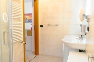 a bathroom with a sink and a toilet at Levante Eight Appartamento Vista Mare in Bari +19 photos