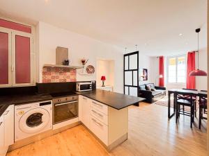 a kitchen and living room with a washer and dryer at Stalingrad - Wifi, AC, 4pers in Nice +10 photos