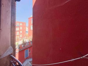 a red wall with a view of a building at Stalingrad - Wifi, AC, 4pers in Nice