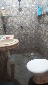 Un baño con un inodoro blanco y un lavabo. en Casa da Família Nascimento, en Ananindeua