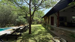 a group of lounge chairs sitting next to a house at Nyne Hotels Mayur Lodge - Yala - All Inclusive in Yala