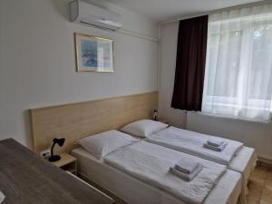 Postel nebo postele na pokoji v ubytování Lencsés Apartmanház Apartmanok